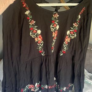 black shirt with red white and green embroidered flowers